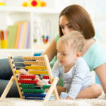 kid playing with abacus